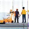 Group of workers installing equipment, possibly solar panels or other energy technology