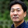 Photo of Eng. Hiroshi Nakamura, possibly in an outdoor or technical setting